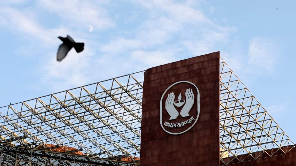 FILE PHOTO: A bird flies past a logo of Life Insurance Corporation of India (LIC) at one of its offices in New Delhi, India September 14, 2021.  REUTERS/Anushree Fadnavis/File Photo