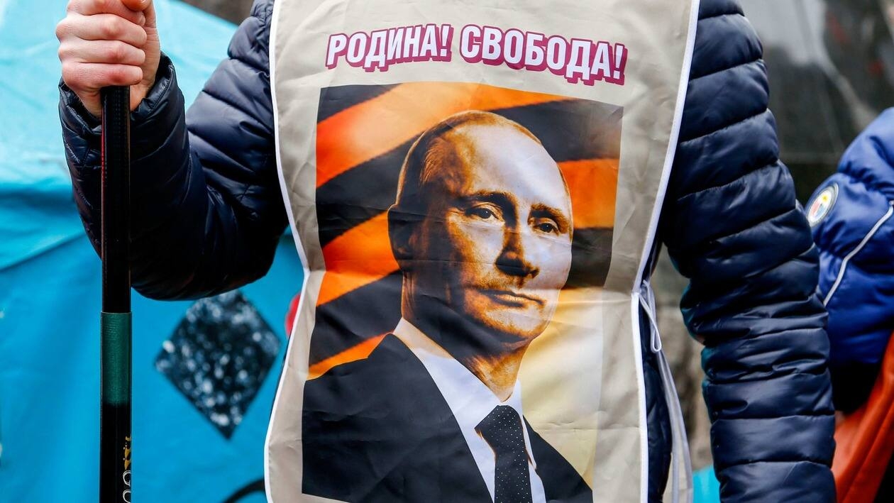 FILE - A pro-Russia demonstrator wears a vest bearing a depiction of Russian President Vladimir Putin and the words, Motherland Freedom during a rally in Donetsk, Ukraine, Sunday, March 16, 2014. Pro-Russia demonstrators in the eastern city of Donetsk called for a referendum similar to the one in Crimea. (AP Photo/Andrey Basevich, File)