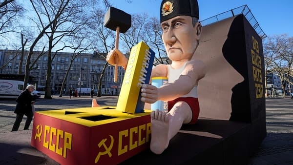 A satirical carnival float depicts Russia's President Vladimir Putin playing with the Ukraine to restore the Soviet Union on a square in Cologne, Germany, during a peace march against the war in Ukraine on Shrove Monday, Feb. 28, 2022. The traditional carnival Rose Monday Parade in Cologne was cancelled due to Russia's war in Ukraine. Instead of the parade, the political carnival floats were placed in the city followed by a peace protest of revelers. (AP Photo/Martin Meissner)