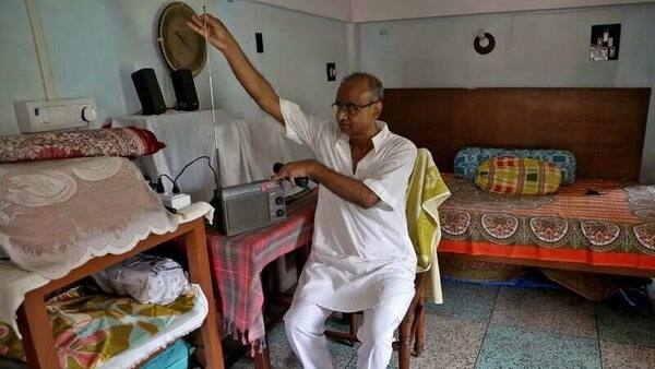 Nikhil Kumar Mondal, 65, a retired school headmaster, adjusts the antenna of his radio inside his house on the outskirts of Kolkata, India, May 20, 2022.  REUTERS/Rupak De Chowdhuri