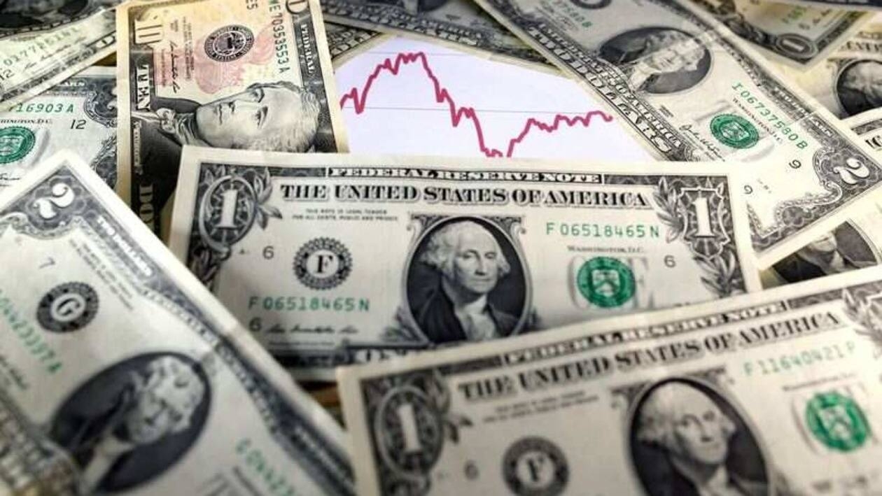FILE PHOTO: U.S. dollar notes are seen in front of a stock graph in this November 7, 2016 picture illustration. REUTERS/Dado Ruvic/Illustration/File Photo