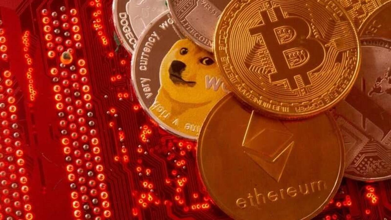 FILE PHOTO: Representations of cryptocurrencies Bitcoin, Ethereum, DogeCoin, Ripple, Litecoin are placed on PC motherboard in this illustration taken, June 29, 2021. REUTERS/Dado Ruvic/Illustration
