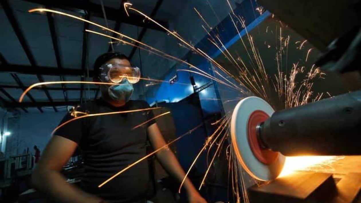 FILE PHOTO: A worker operates a lathe machine as he makes a steel cutter at a manufacturing unit in Noida, on the outskirts of New Delhi November 3, 2014. Indian factory activity expanded at a modest pace in October, as stronger demand led manufacturers to add jobs for the first time in four months and allowed them to raise prices, a business survey showed on Monday. REUTERS/Anindito Mukherjee