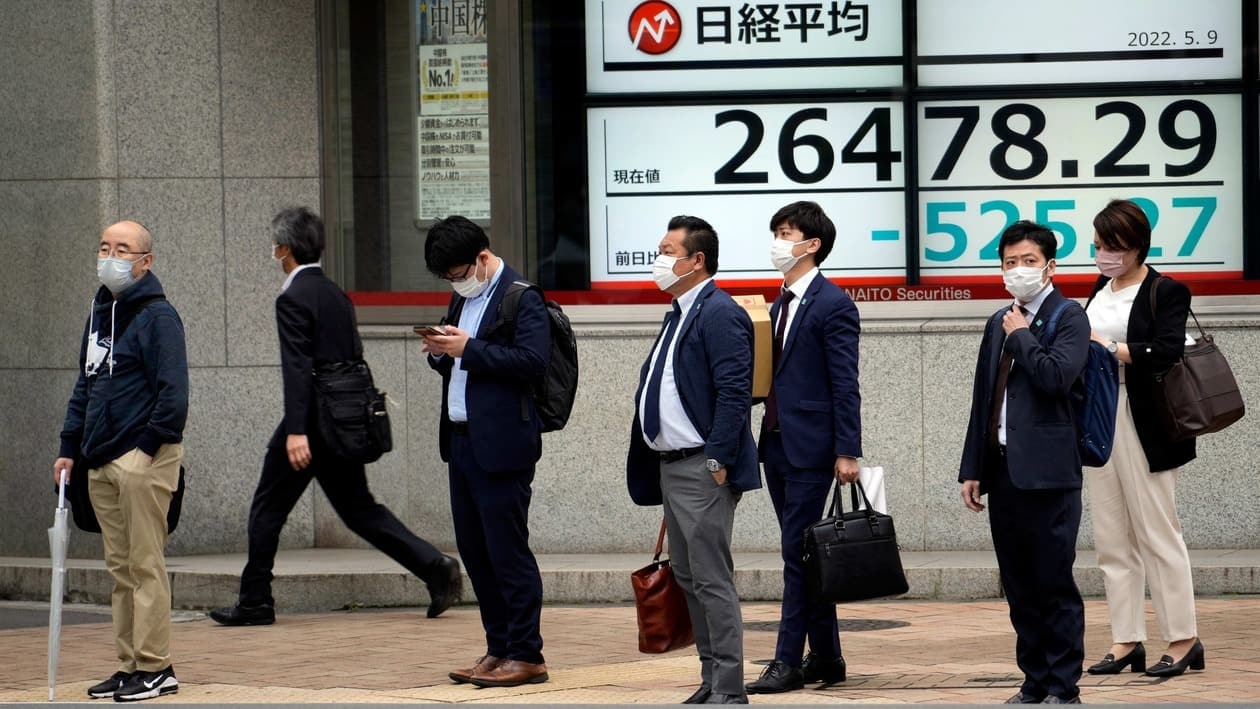 Tokyo : People wearing protective masks stand in front of an electronic stock board showing Japan's Nikkei 225 index at a securities firm Monday, May 9, 2022, in Tokyo. Shares fell in most Asian markets on Monday as interest rate hikes and a slowing Chinese economy weighed on investor sentiment. AP/PTI(AP05_09_2022_000022A)