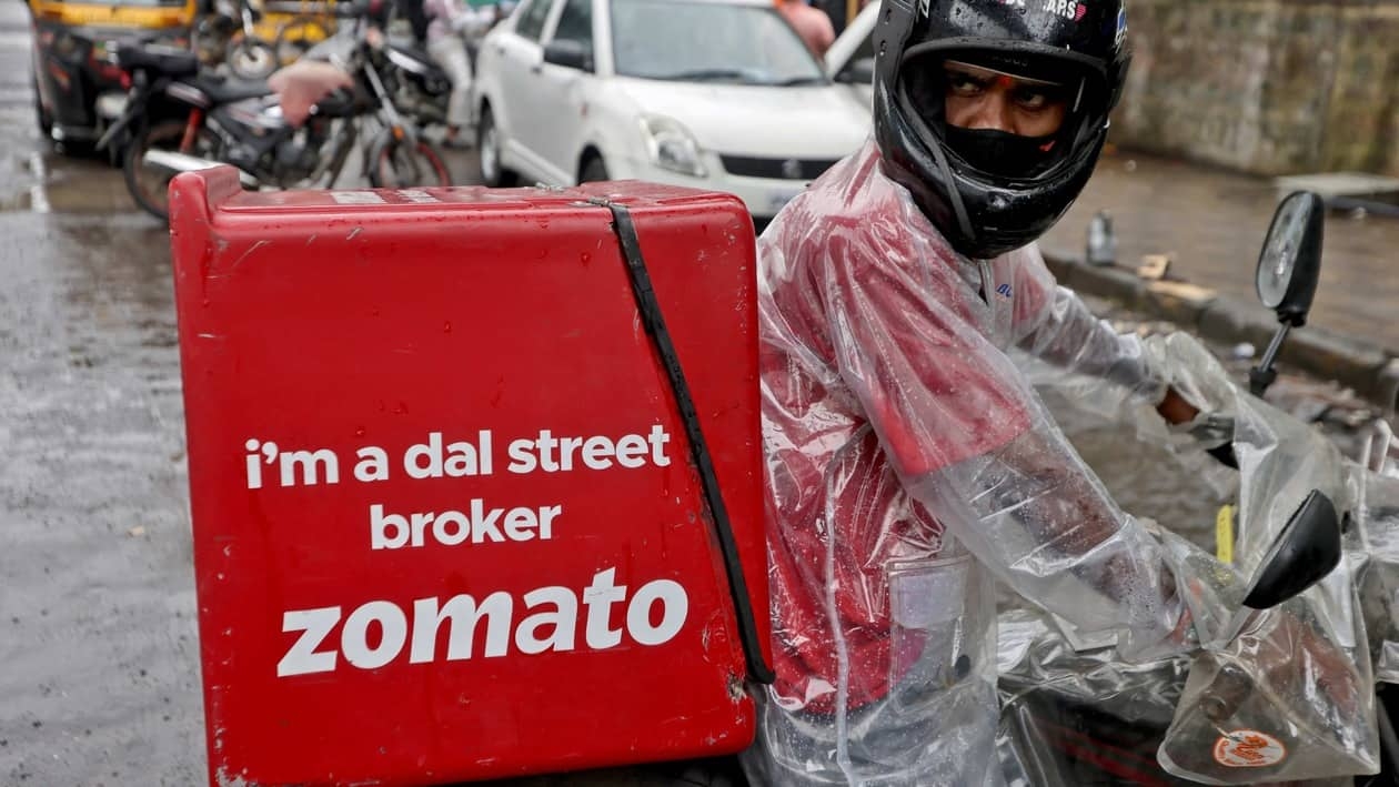 FILE PHOTO: A delivery worker of Zomato, an Indian food-delivery startup, prepares to leave to pick up an order from a restaurant in Mumbai, India, July 13, 2021. REUTERS/Francis Mascarenhas/File Photo