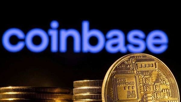 FILE PHOTO: A representation of the cryptocurrency is seen in front of Coinbase logo in this illustration taken, March 4, 2022. REUTERS/Dado Ruvic/Illustration