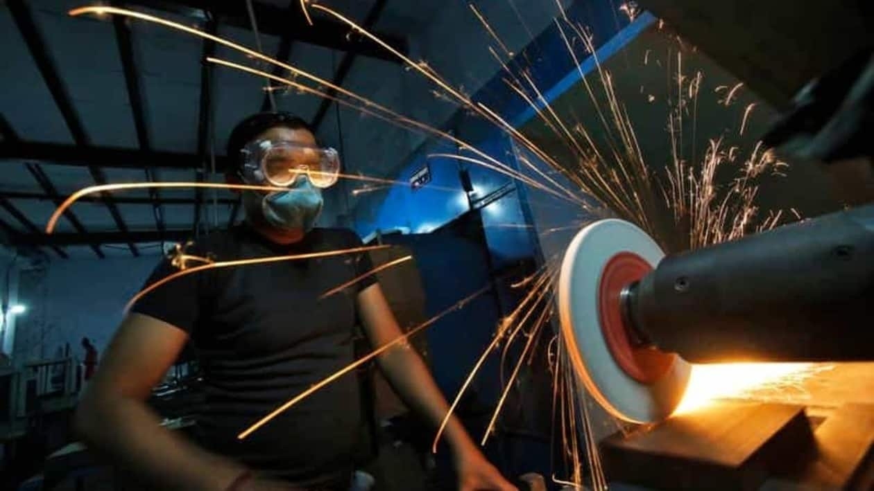 FILE PHOTO: A worker operates a lathe machine as he makes a steel cutter at a manufacturing unit in Noida, on the outskirts of New Delhi November 3, 2014. Indian factory activity expanded at a modest pace in October, as stronger demand led manufacturers to add jobs for the first time in four months and allowed them to raise prices, a business survey showed on Monday. REUTERS/Anindito Mukherjee