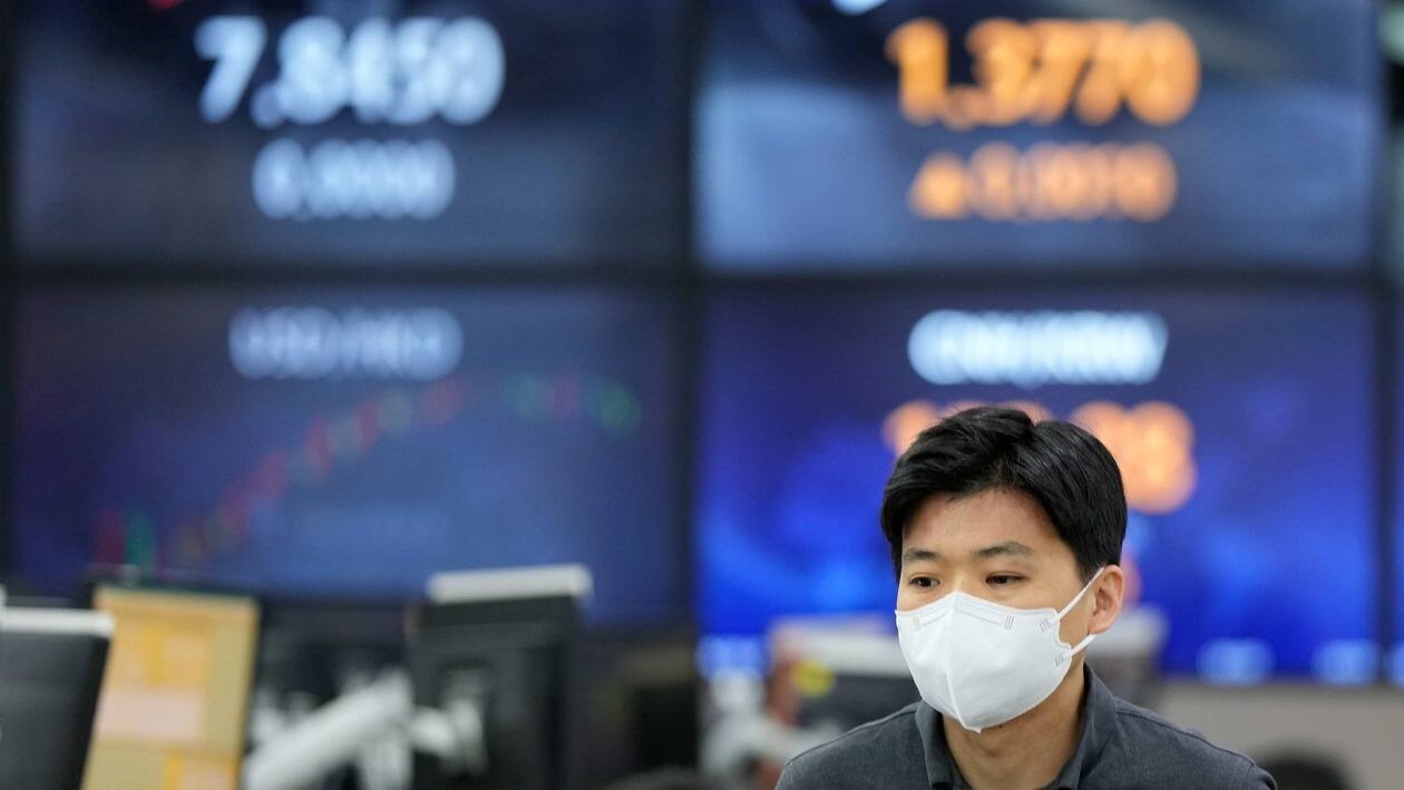 A currency trader walks near the screens showing the foreign exchange rates at a foreign exchange dealing room in Seoul, South Korea, Tuesday, June 7, 2022.  Asian stock markets were mixed Tuesday following a bond sell-off on Wall Street amid anxiety about higher U.S. interest rates. (AP Photo/Lee Jin-man)