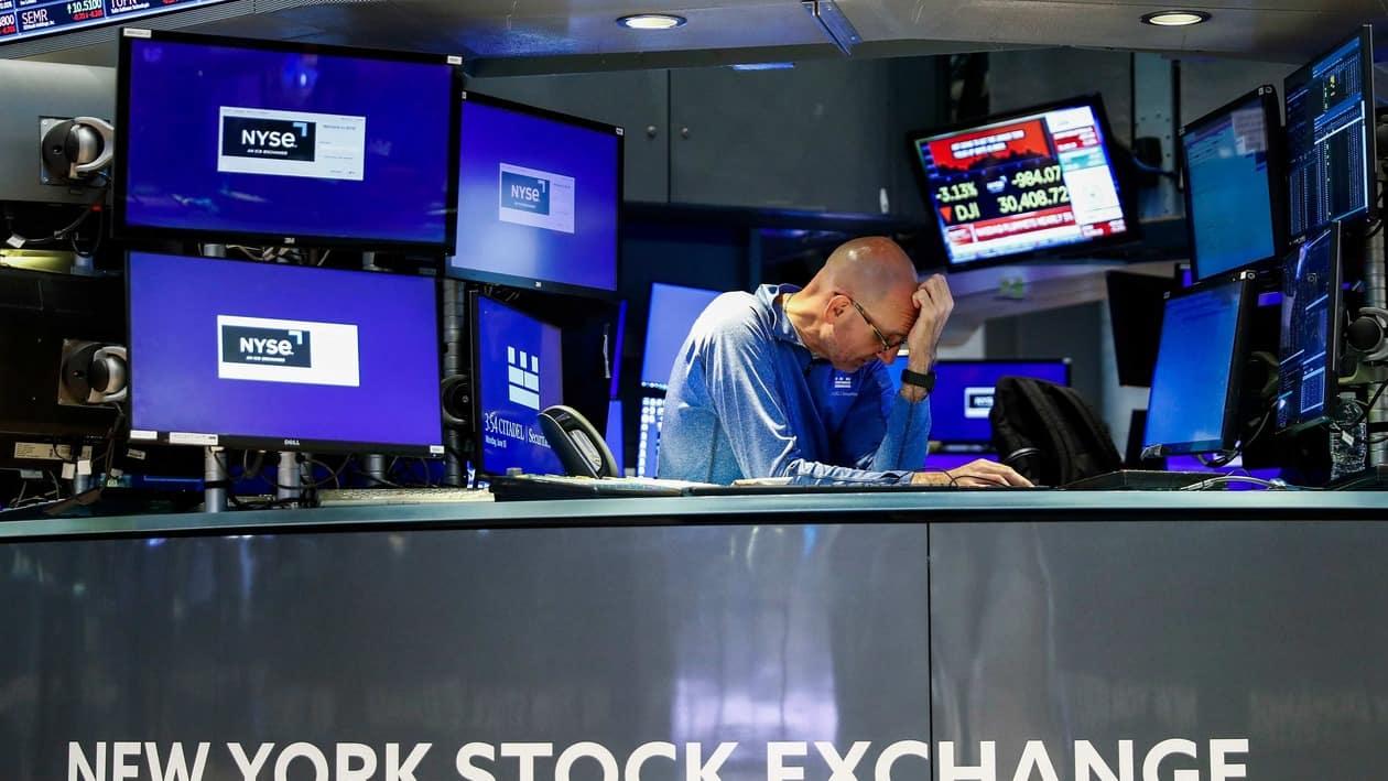 In this photo provided by the New York Stock Exchange, trader Michael Conlon works on the floor, Monday, June 13, 2022. Fears about a possible recession are pounding markets worldwide on Monday, and Wall Street's S&P 500 tumbled into the maw of what's known as a bear market after sinking more than 20% below its record set early this year. (Courtney Crow/New York Stock Exchange via AP)