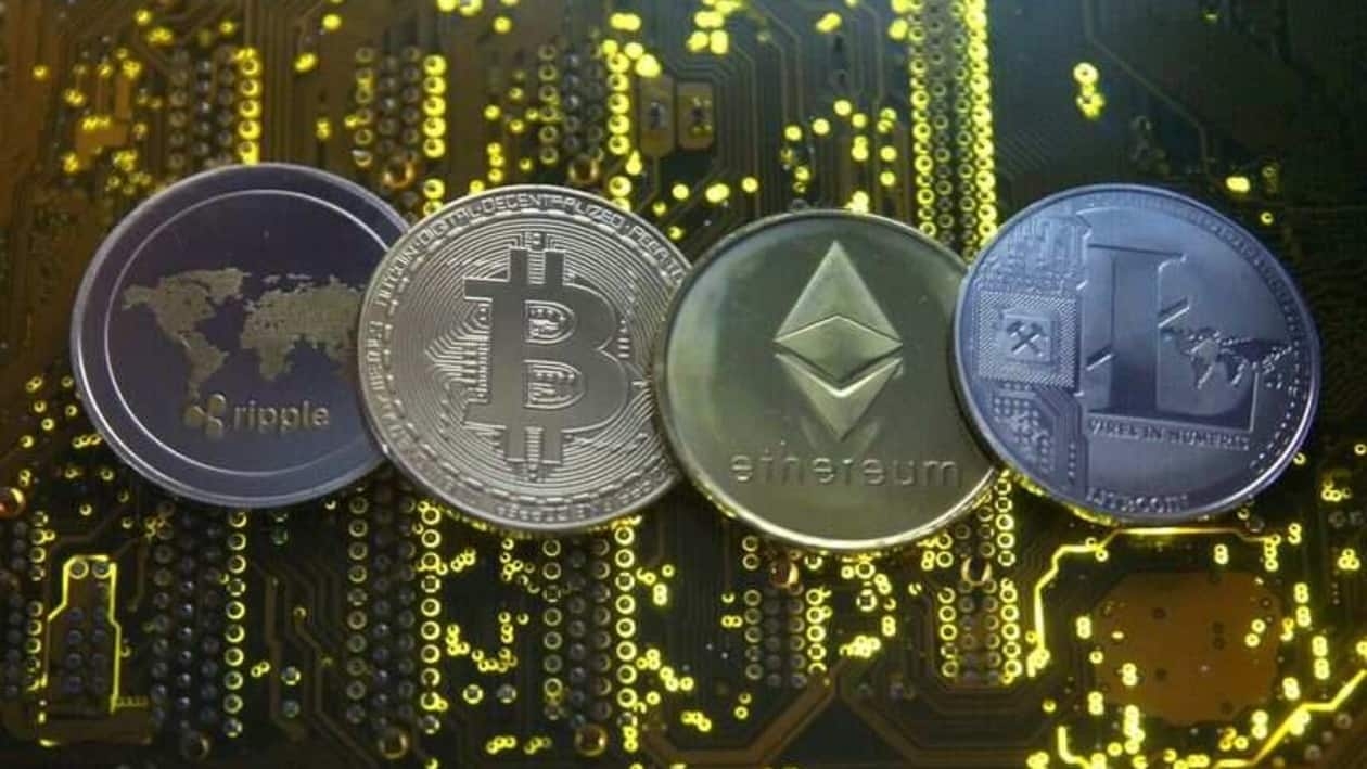 FILE PHOTO: Representations of the Ripple, Bitcoin, Etherum and Litecoin virtual currencies are seen on a PC motherboard in this illustration picture, February 14, 2018. REUTERS/Dado Ruvic/File Photo