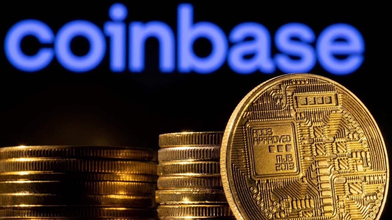 FILE PHOTO: A representation of the cryptocurrency is seen in front of Coinbase logo in this illustration taken, March 4, 2022. REUTERS/Dado Ruvic/Illustration/File Photo