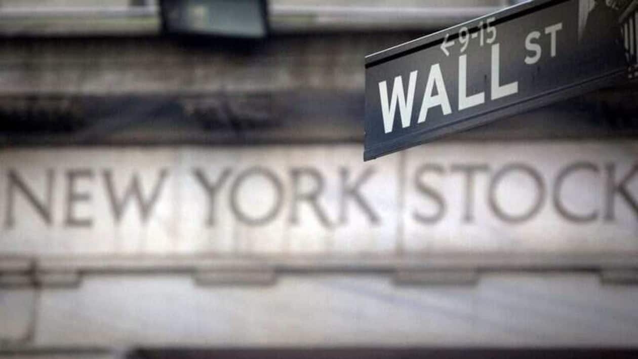 FILE PHOTO: A Wall Street sign is pictured outside the New York Stock Exchange in New York, October 28, 2013. REUTERS/Carlo Allegri