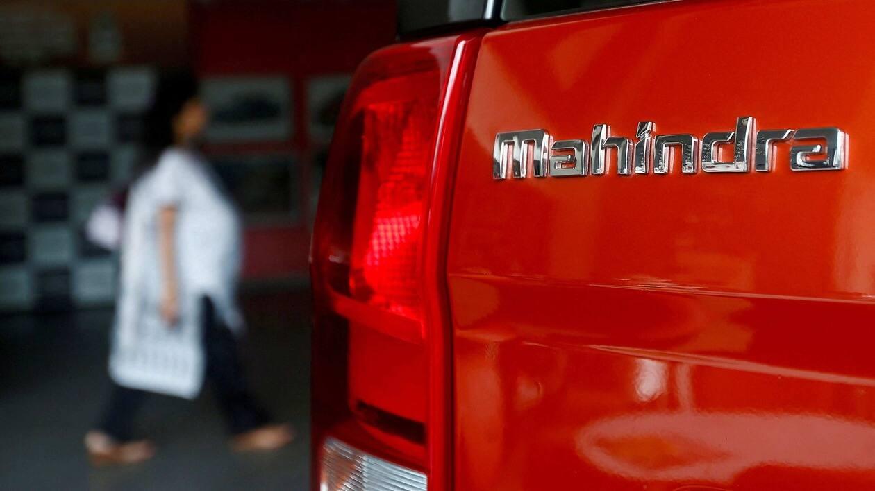 FILE PHOTO: FILE PHOTO: An employee walks past a Mahindra TUV300 car at a showroom in Mumbai, India, August 30, 2016. Picture taken August 30, 2016. REUTERS/Danish Siddiqui/File Photo