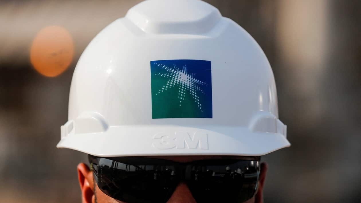 FILE PHOTO: An employee in a branded helmet is pictured at Saudi Aramco oil facility in Abqaiq, Saudi Arabia October 12, 2019. REUTERS/Maxim Shemetov/File Photo