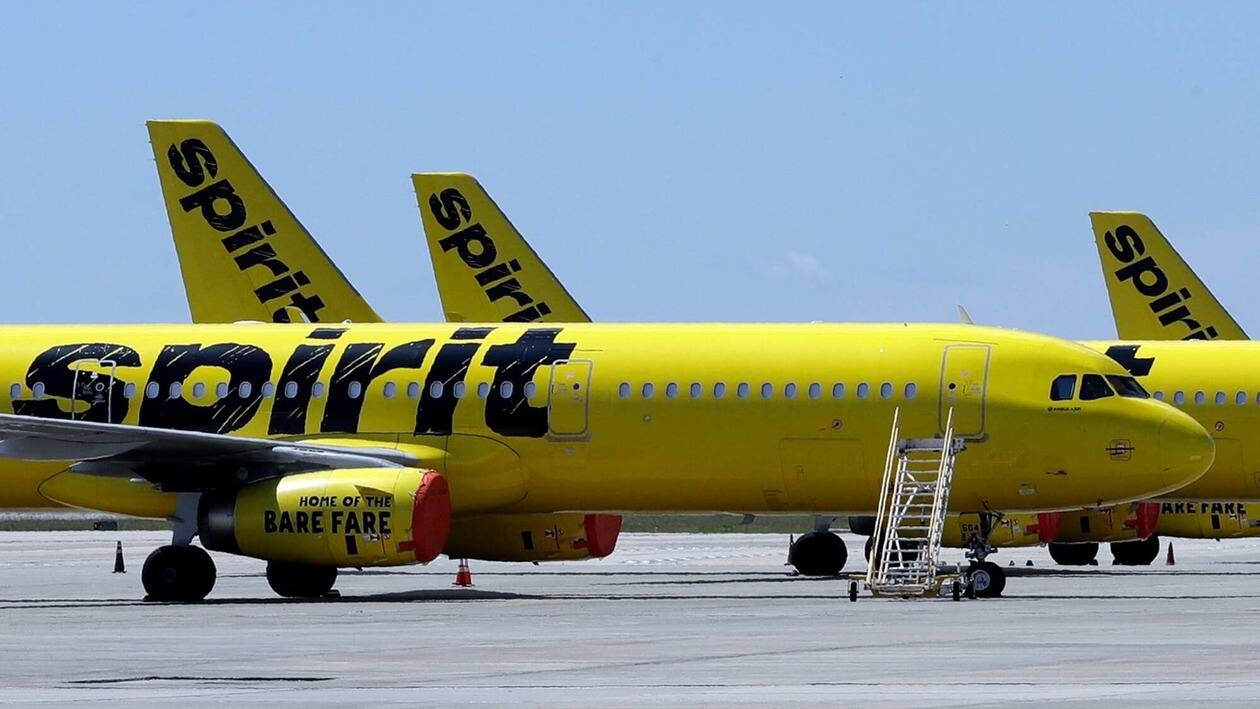 FLE - A line of Spirit Airlines jets sit on the tarmac at the Orlando International Airport on May 20, 2020, in Orlando, Fla.  Shareholders of Spirit Airlines will vote Thursday, June 29, 2022, on a proposed merger with Frontier Airlines, and the outcome could affect fares for millions of air travelers who depend on the budget airlines.     (AP Photo/Chris O'Meara, File)