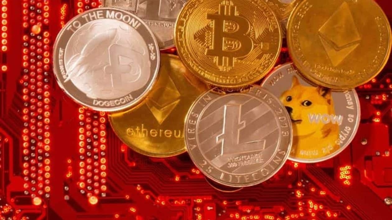 FILE PHOTO: Representations of cryptocurrencies Bitcoin, Ethereum, DogeCoin, Ripple, Litecoin are placed on PC motherboard in this illustration taken, June 29, 2021. REUTERS/Dado Ruvic/Illustration/File Photo