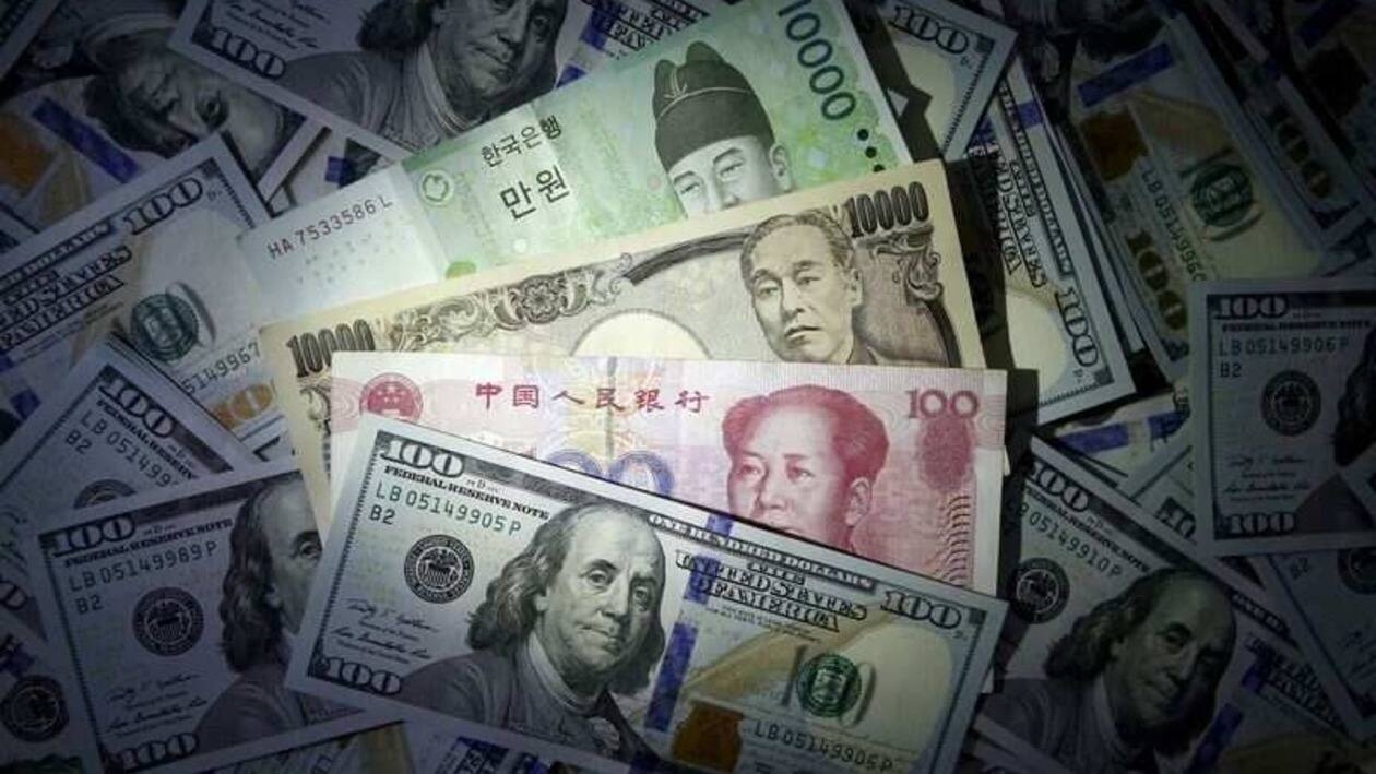 FILE PHOTO: South Korean won, Chinese yuan and Japanese yen notes are seen on U.S. $100 notes in this file photo illustration shot December 15, 2015. REUTERS/Kim Hong-Ji//Illustration