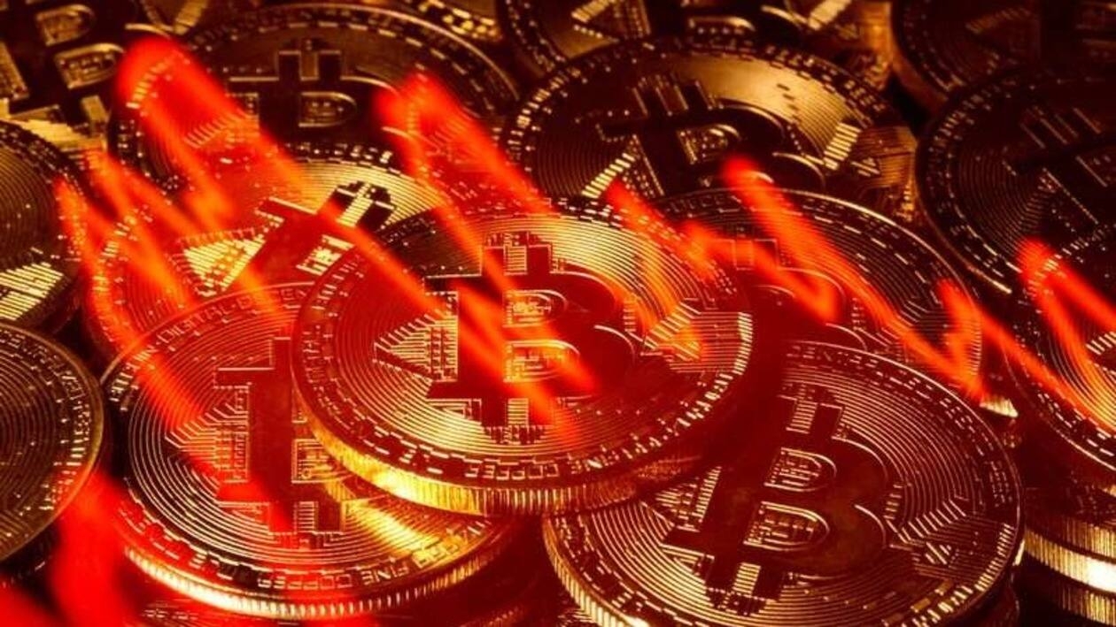 FILE PHOTO: Illumination of the stock graph is seen on the representations of virtual currency Bitcoin in this picture illustration taken taken March 13, 2020. REUTERS/Dado Ruvic/Illustration/File Photo