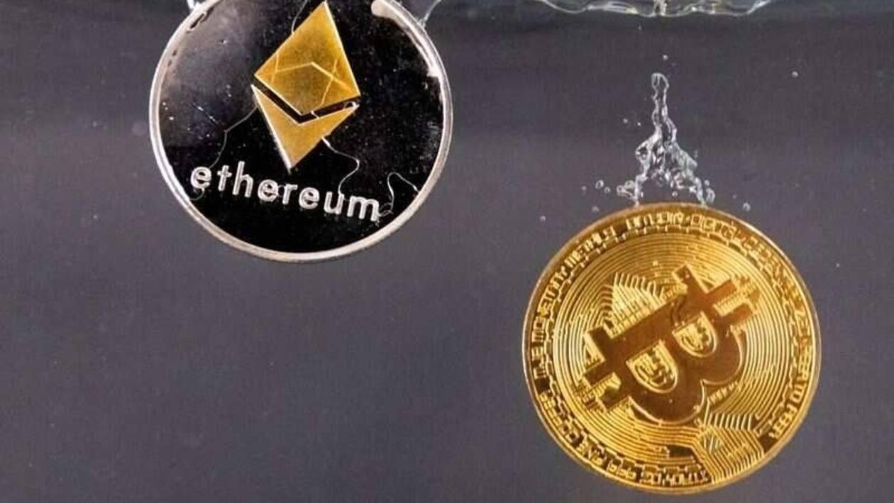 FILE PHOTO: Souvenir tokens representing cryptocurrency Bitcoin and the Ethereum network, with its native token ether, plunge into water in this illustration taken May 17, 2022. REUTERS/Dado Ruvic/Illustration