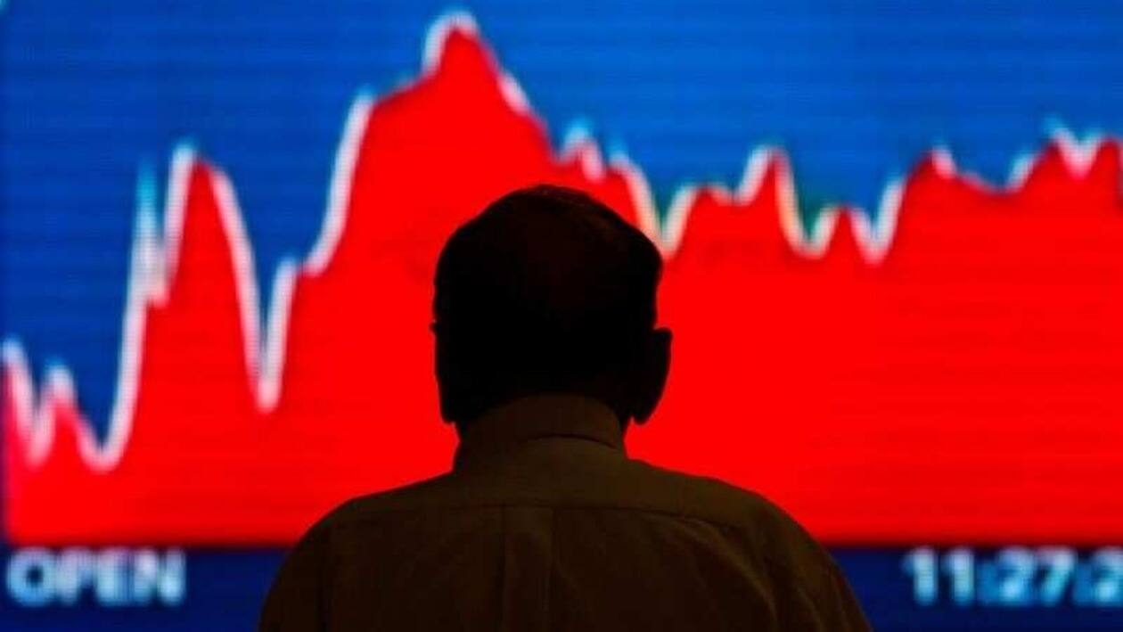 FILE PHOTO: A man looks at a screen displaying news of markets update inside the Bombay Stock Exchange (BSE) building in Mumbai, India June 20, 2016. REUTERS/Danish Siddiqui