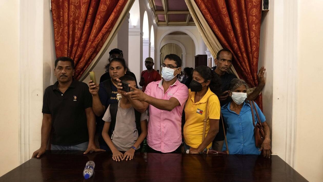 People takes picture inside the official residence of president Gotabaya Rajapaksa fourth days after it was stormed by anti government protesters in Colombo in Colombo, Sri Lanka, Wednesday, July 13, 2022. The president of Sri Lanka fled the country early Wednesday, days after protesters stormed his home and office and the official residence of his prime minister amid a monthslong economic crisis that triggered severe shortages of food and fuel. (AP Photo/Rafiq Maqbool)