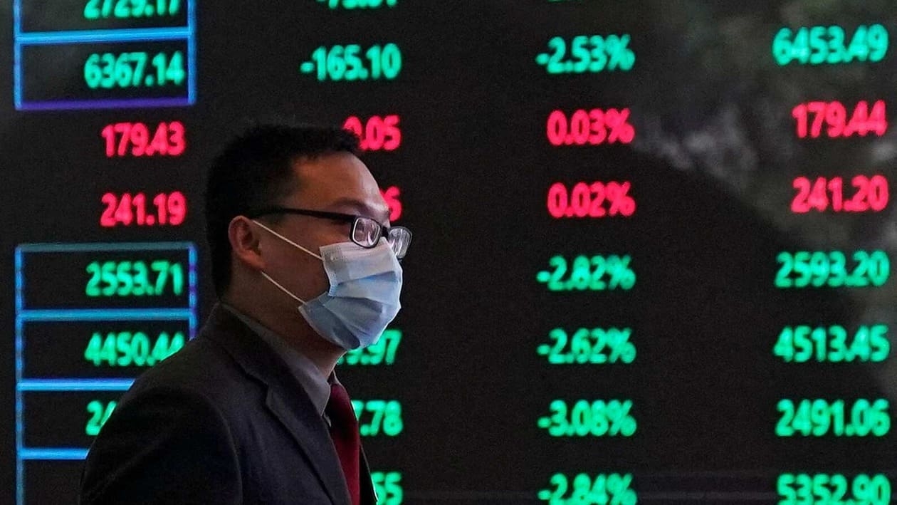FILE PHOTO: FILE PHOTO: A man wearing a protective mask is seen inside the Shanghai Stock Exchange building at the Pudong financial district in Shanghai, China February 28, 2020. REUTERS/Aly Song/File Photo/File Photo