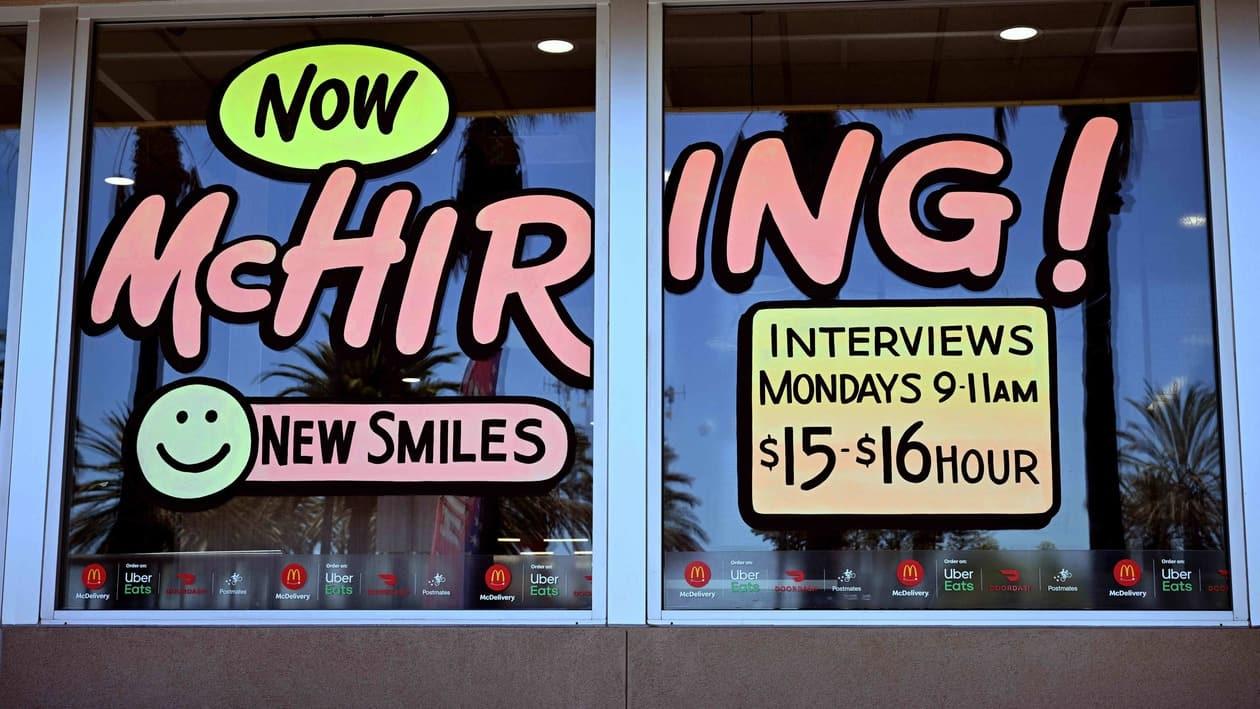 A Hiring sign is pictured at a McDonald's restaurant in Garden Grove, California on July 8, 2022. &nbsp;The US economy added far more jobs than expected in June and wages rose, adding fuel to worries about accelerating inflation, but giving President Joe Biden a reason to cheer. Biden has seen his approval ratings plummet as Americans face the worst inflation surge in more than 40 years, but after the latest data Friday, he underscored the rapid jobs recovery in the wake of the pandemic. (Photo by Robyn BECK / AFP)