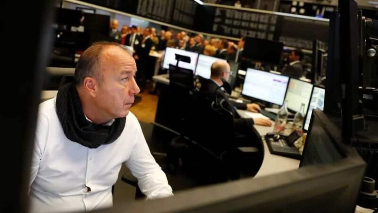 A share trader checks his screens at the stock exchangee in Frankfurt, Germany, November 20, 2017. REUTERS/Kai Pfaffenbach/Files