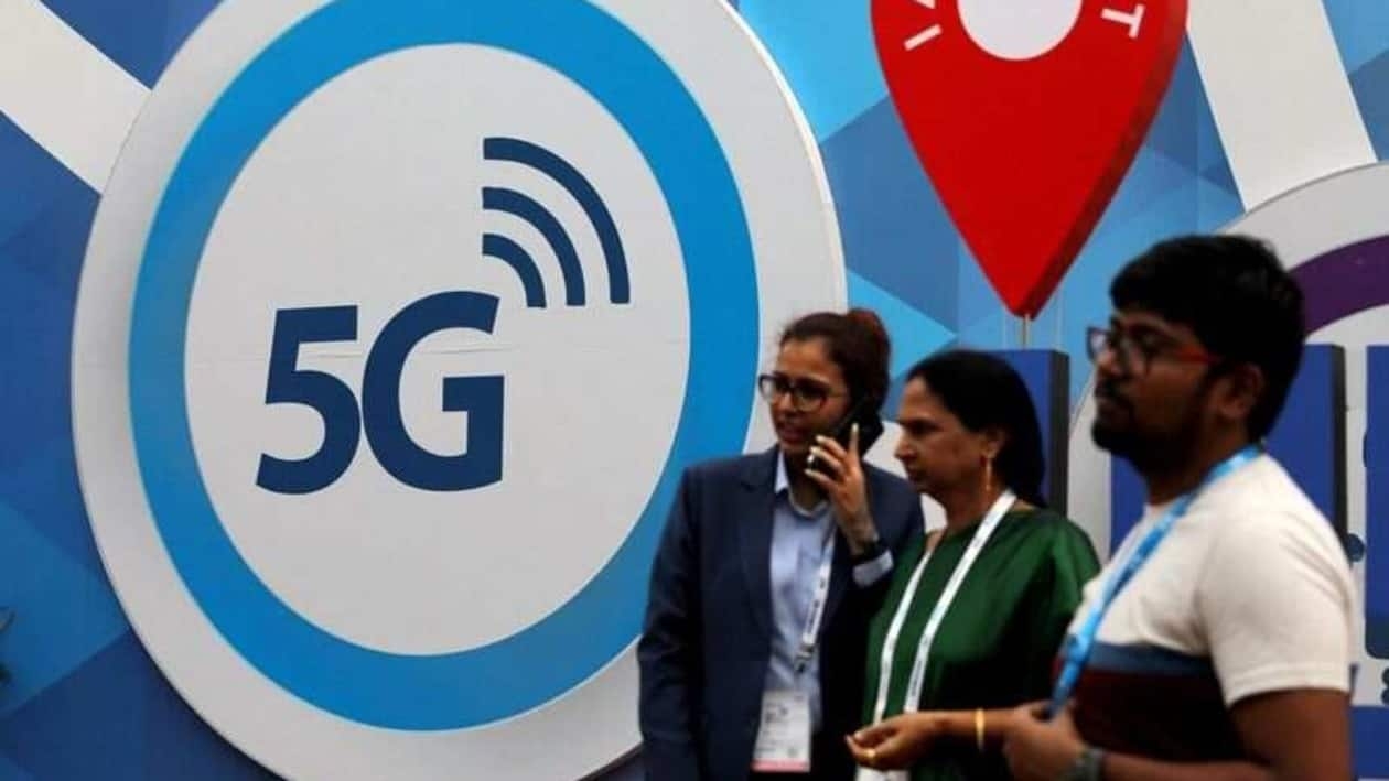 FILE PHOTO: People stand in front of a board depicting 5G network at the India Mobile Congress 2018 in New Delhi, India, October 26, 2018. REUTERS/Anushree Fadnavis