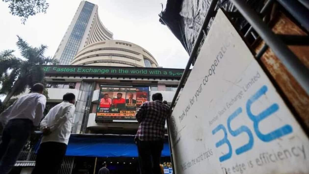 FILE PHOTO: People stand outside the Bombay Stock Exchange (BSE), after Sensex surpassed the 60,000 level for the first time, in Mumbai, India, September 24, 2021. REUTERS/Francis Mascarenhas/File Photo