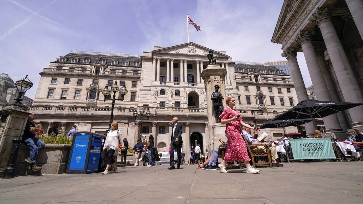 FILE - People walk outside the Bank of England, in the financial district known as The City, in London, Thursday, June 16, 2022. U.K. inflation accelerated to a new 40-year high in June, driven by rising food and fuel prices. Bank of England Governor Andrew Bailey said Tuesday, July 19, 2022, that the bank is likely to consider raising interest rates by 0.5 percentage points at its next meeting to help control inflation. (AP Photo/Alberto Pezzali, File)