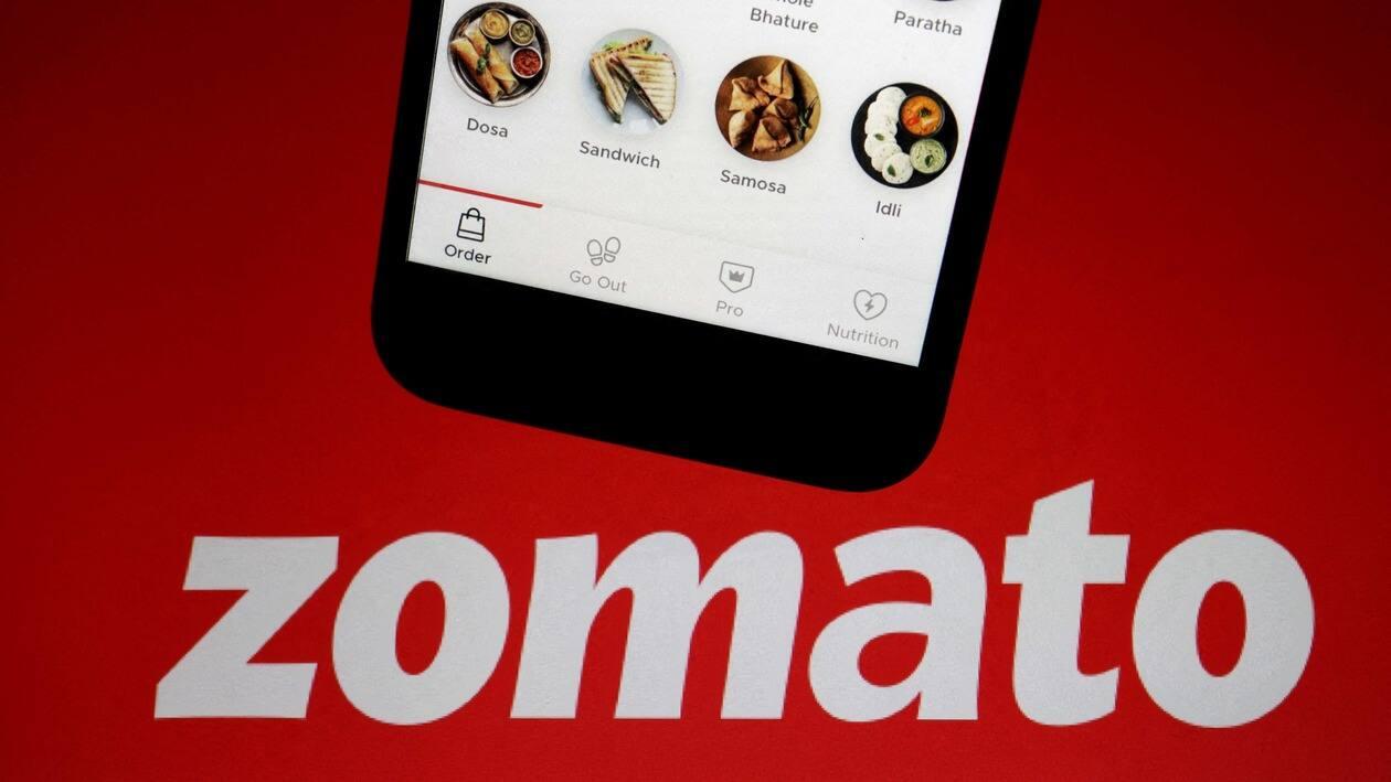 The app of Indian food delivery company Zomato is seen on a mobile phone above its logo displayed in this illustration picture taken July 14, 2021. REUTERS/Florence Lo/Illustration/File Photo/File Photo