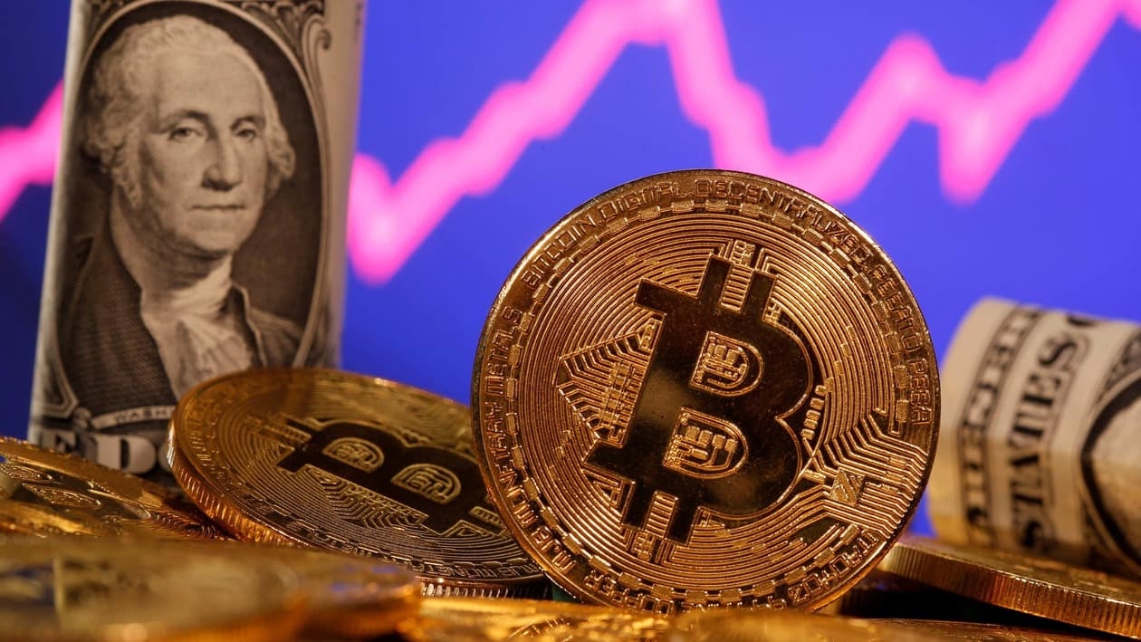 FILE PHOTO: A representation of virtual currency bitcoin and a U.S. one dollar banknote are seen in front of a stock graph in this illustration taken January 8, 2021. REUTERS/Dado Ruvic/File Photo