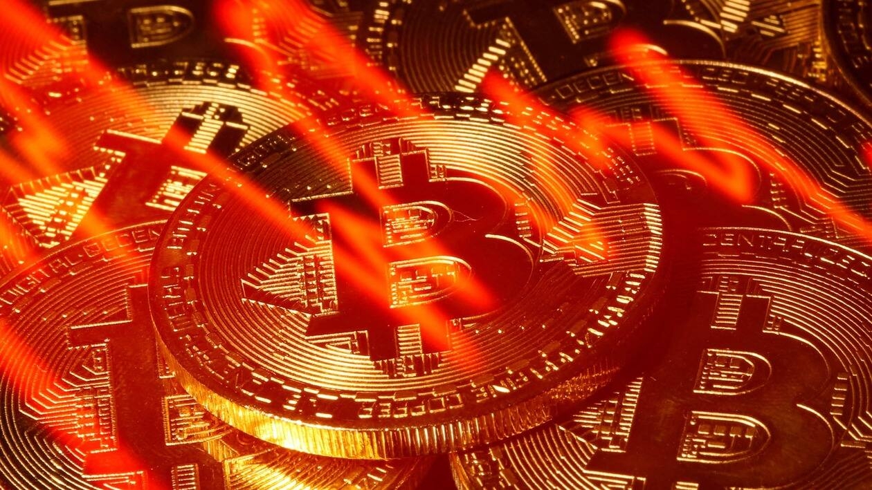 FILE PHOTO: A stock graph is seen with a representation of bitcoin in this picture illustration taken taken March 13, 2020. REUTERS/Dado Ruvic/File Photo