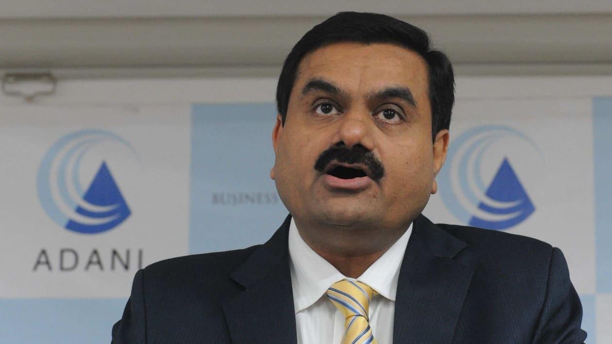 (FILES) In this file photo taken on December 23, 2010 chairman of the Adani Group Gautam Adani speaks during a press conference in Ahmedabad. - Indian billionaire Gautam Adani struck a $10.5-billion deal to buy Swiss cement giant Holcim's local business, the companies said on May 15, 2022, betting on a construction boom predicted in coming decades. (Photo by Sam PANTHAKY / AFP)