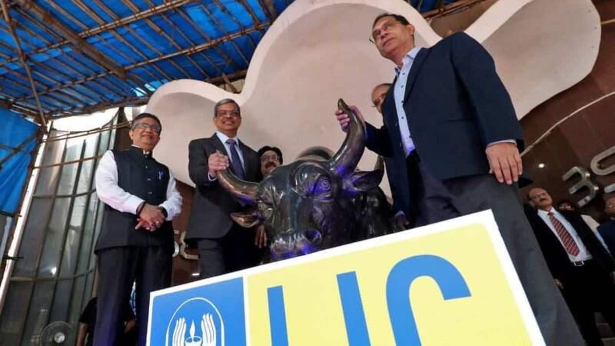 Ashishkumar Chauhan, MD and CEO of Bombay Stock Exchange (BSE), Life Insurance Corporation of India (LIC) Chairperson Mangalam Ramasubramanian Kumar and Tuhin Kanta Pandey, Secretary Department of Investment and Public Asset Management (DIPAM), pose with a bronze replica of the Charging Bull of Wall Street, after the company's IPO listing ceremony at the Bombay Stock Exchange (BSE) in Mumbai, India, May 17, 2022. REUTERS/Niharika Kulkarni