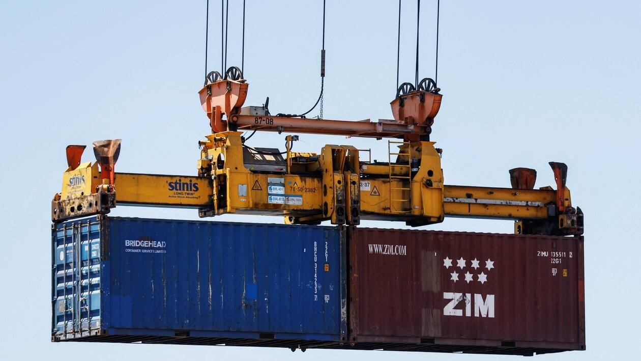Cargo containers are unloaded from a ship at Haifa Port, which is to be sold to India's Adani Ports and local partner Gadot in Haifa, Israel July 24, 2022. REUTERS/Amir Cohen