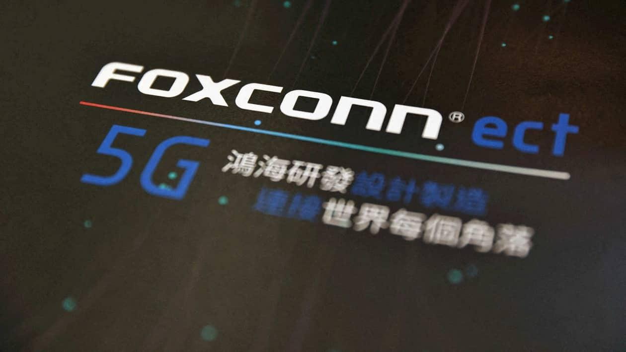 FILE PHOTO: A poster with a logo of Foxconn is seen at the IEEE Global Communications Conference in Taipei. Taiwan, December 9, 2020. REUTERS/Ann Wang/File Photo/File Photo
