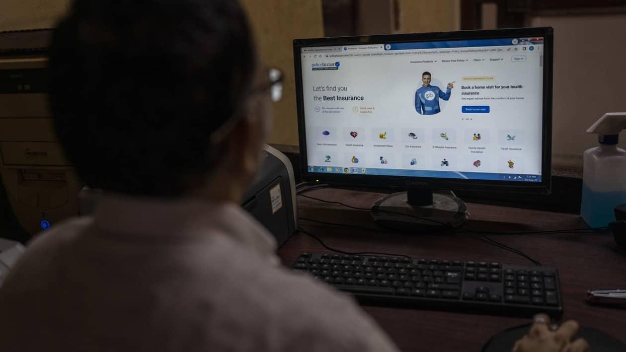 A man looks at the website of policybazaar website at a local insurance company office in Mumbai, India, Wednesday, Aug. 10, 2022. A cybersecurity firm told the major Indian online insurance brokerage last month that critical vulnerabilities in the company’s internet-facing network could expose sensitive personal and financial data from its 11 million customers. CyberX9 followed the standard ethical-hacker playbook, giving the brokerage time to patch the flaws and inform authorities. A week later, publicly traded Policybazaar said it had been illegally breached but “no significant customer data was exposed.” (AP Photo/Rafiq Maqbool)