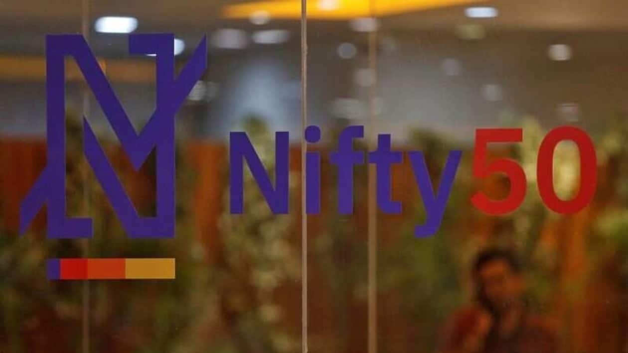 FILE PHOTO: A man speaks on his mobile phone past a new brand identity for Nifty Indices inside the National Stock Exchange (NSE) building in Mumbai, India, May 28, 2019. REUTERS/Francis Mascarenhas