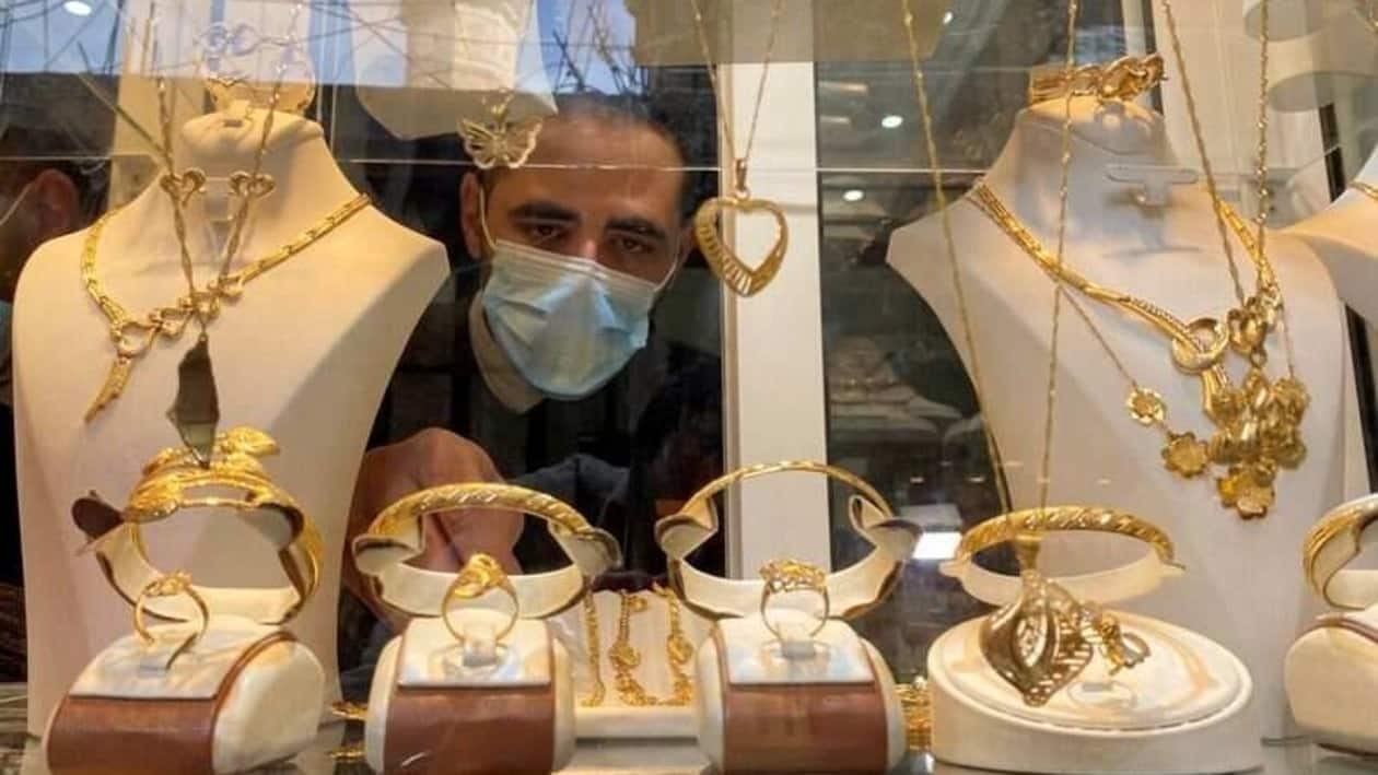 FILE PHOTO: Palestinian Christian jeweller Melad Al-Amash arranges gold jewellery at his shop in Gaza City December 7, 2020.  REUTERS/Mohammed Salem