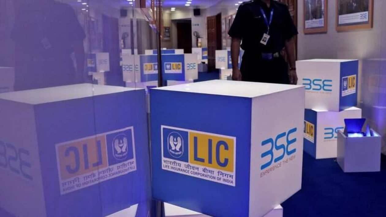 FILE PHOTO: A security guard walks past logos of Life Insurance Corporation of India (LIC) and Bombay Stock Exchange (BSE) inside the BSE building in Mumbai, India, May 17, 2022. REUTERS/Niharika Kulkarni