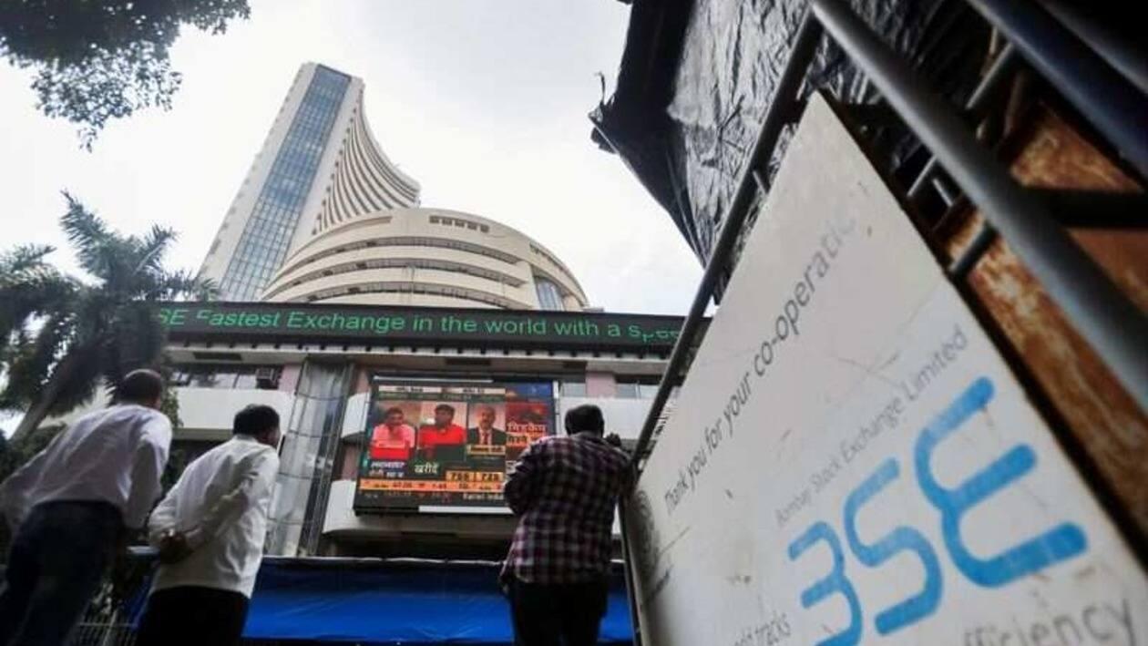 FILE PHOTO: People stand outside the Bombay Stock Exchange (BSE), after Sensex surpassed the 60,000 level for the first time, in Mumbai, India, September 24, 2021. REUTERS/Francis Mascarenhas/File Photo