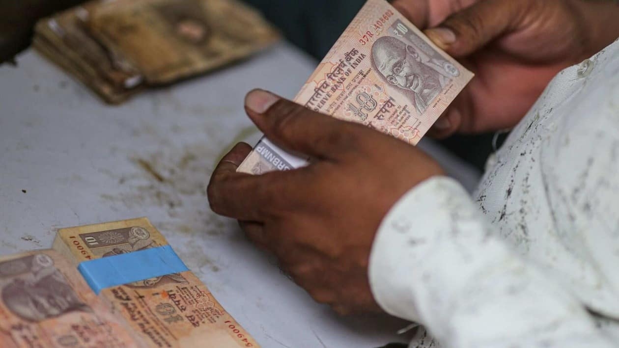 An collectible banknote buyer holds Indian rupee banknotes in Mumbai, India, on Wednesday, July 20, 2022. The rupee slid to all-time low of 80.06 per dollar on Tuesday, and has lost 2.4% over the past month, the third-worst performing Asian currency over the period. Photographer: Dhiraj Singh/Bloomberg