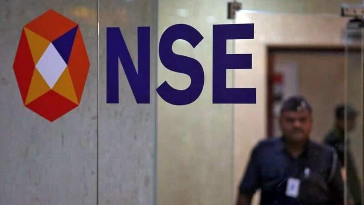FILE PHOTO: A security guard walks past the logo of the National Stock Exchange (NSE) inside its building in Mumbai, India, May 28, 2019. REUTERS/Francis Mascarenhas/File Photo