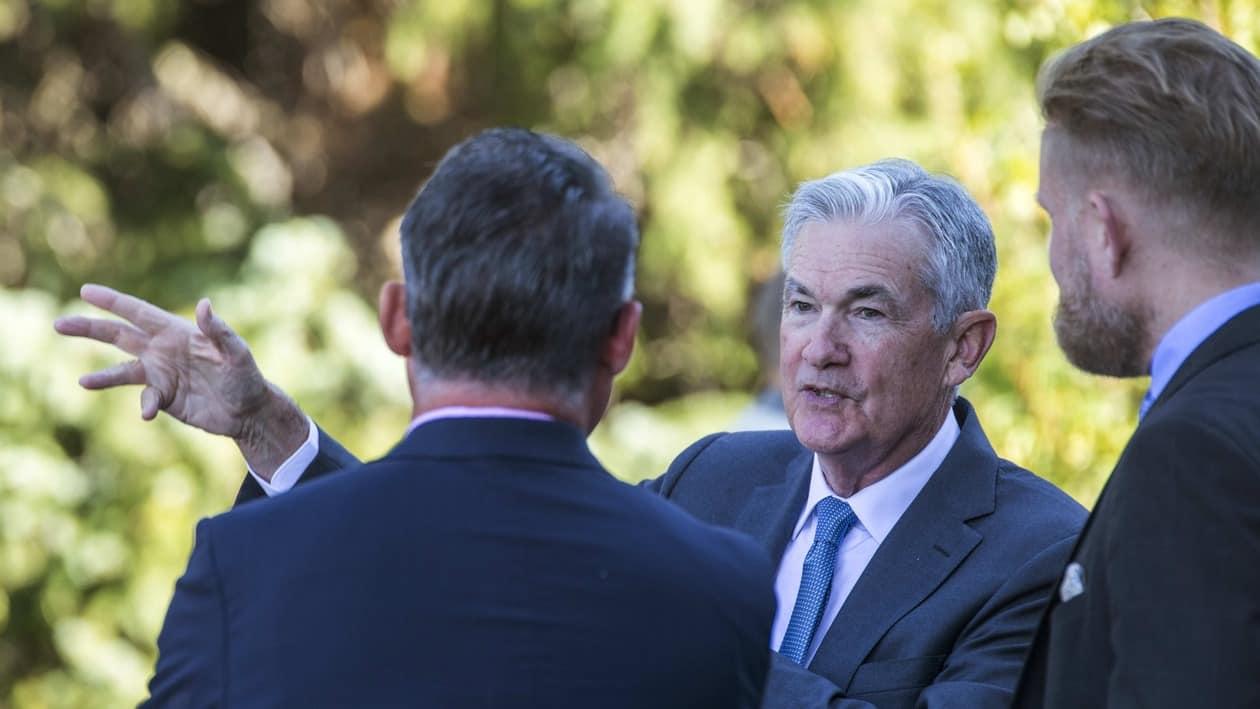 Federal Reserve Chair Jerome Powell, center, takes a coffee break with attendees of the central bank's annual symposium at Jackson Lake Lodge in Grand Teton National Park Friday, Aug. 26, 2022. in Moran, Wyo. (AP Photo/Amber Baesler)