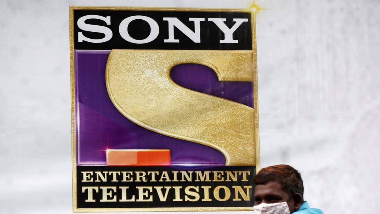 FILE PHOTO: A man stands next to a banner of Sony Entertainment, outside a film set in Mumbai, India, September 24, 2021. REUTERS/Francis Mascarenhas/File Photo