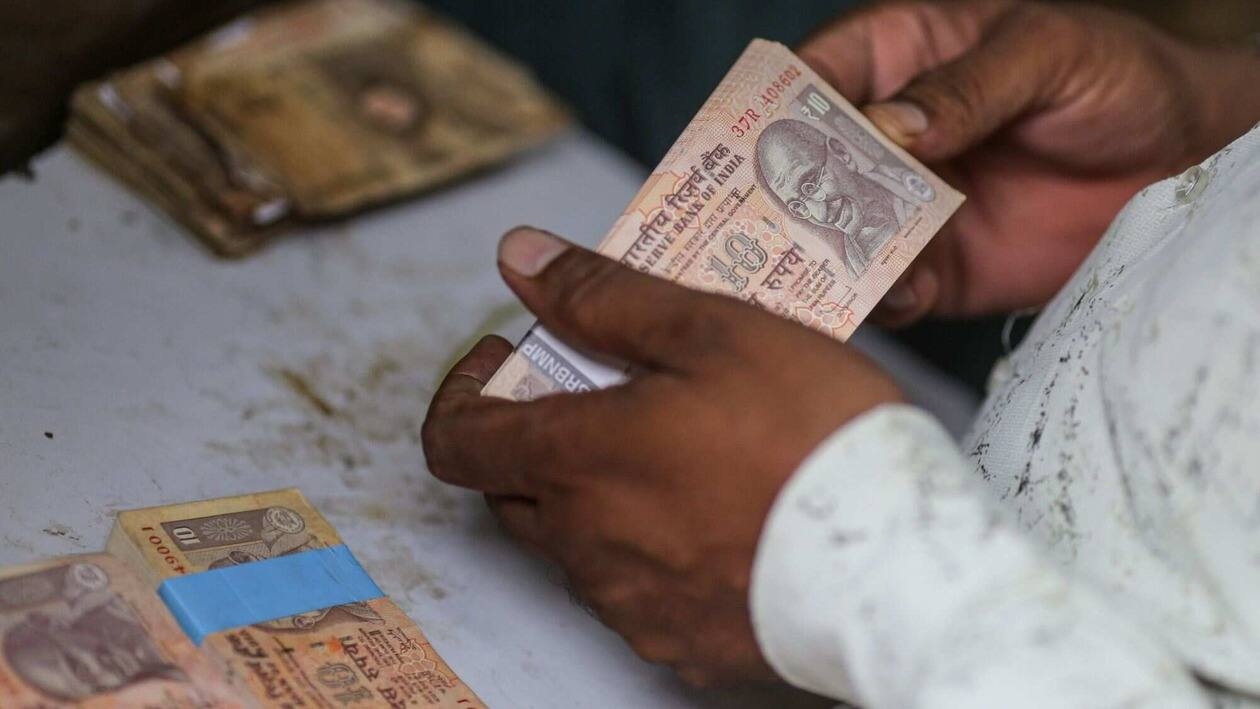 An collectible banknote buyer holds Indian rupee banknotes in Mumbai, India, on Wednesday, July 20, 2022. The rupee slid to all-time low of 80.06 per dollar on Tuesday, and has lost 2.4% over the past month, the third-worst performing Asian currency over the period. Photographer: Dhiraj Singh/Bloomberg