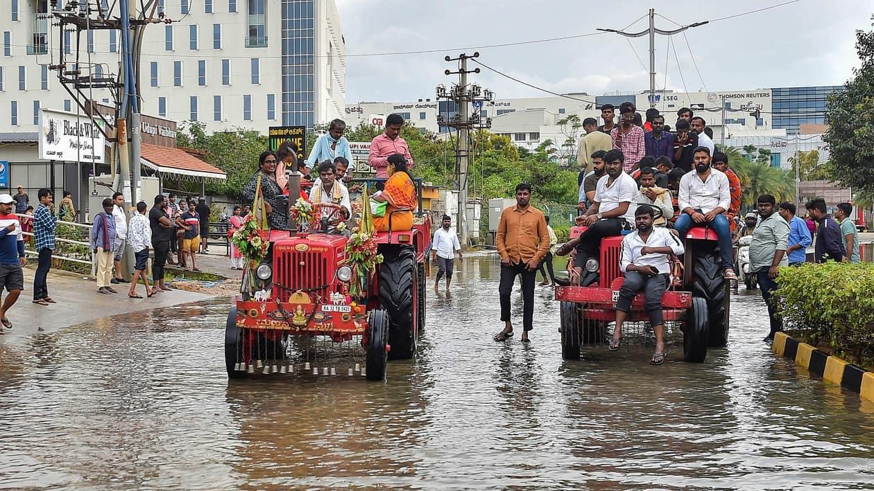 Bengaluru: Tractors being used to evacuate people stranded at the waterlogged Yemalur area after heavy monsoon rains, in Bengaluru, Tuesday, Sept. 6, 2022. (PTI Photo/Shailendra Bhojak)(PTI09_06_2022_000204A)