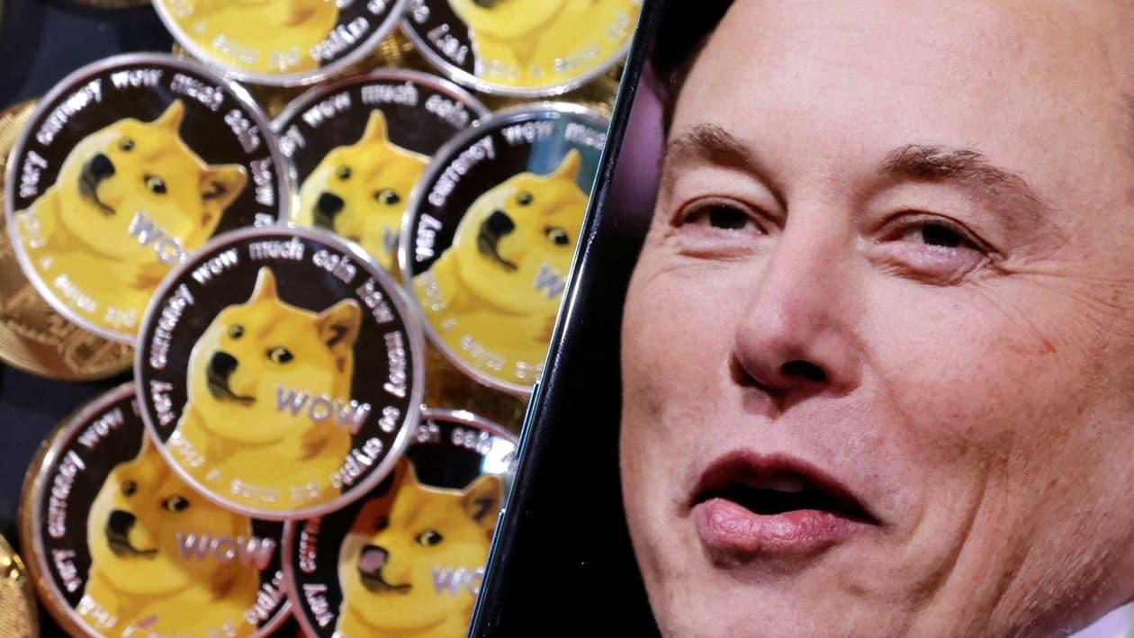 FILE PHOTO: A photo of Elon Musk is displayed on a smartphone placed on representations of cryptocurrency Dogecoin in this illustration taken June 16, 2022. REUTERS/Dado Ruvic/Illustration/File Photo